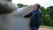 Tony Pollard at the bow of a ship. Tony is on the way to the location where the remains of the Tirpitz rests.