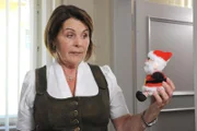 Rosi (Brigitte Walbrun) schaut den sprechenden Nikolaus, den Ulla in die Amtsstube stellen will, skeptisch an.