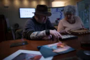 At team headquarters, Bill Hartley and Dana Mitchell go over evidence of Nina Cruz's hauntings.