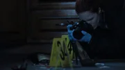 Recreation- An investigator photographs evidence at the Jones murder scene.