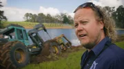 On a farm in Manjimup, a skidder is in danger of sinking into the water.