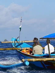 Forrest Galante and crew members ride a dugout canoe to reach an isolated forest in eastern Java.