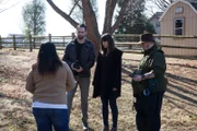 Nina Cruz explains to Nick Groff, Elizabeth Saint, and Bill Hartley about her home being cursed.