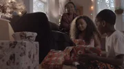 A woman and children are with presents.