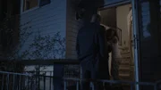 Two women cry in foyer while Demery stands in the doorway.