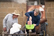 Kempton, Tasmania - L to R: Peter Bignell and Gordon Ramsay grind rye grains at Belgrove Distillery.