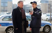 Dr. Roland Heilmann (Thomas Rühmann, li.) trifft vor der Klinik auf seinen Enkel Jonas (Anthony Petrifke, re.). Dieser ist dienstlich da und soll einen Autounfall mit Fahrerflucht aufklären. Die dabei Geschädigte liegt in der Sachsenklinik.