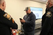 Officer David Schweizer speaks with two other officers.