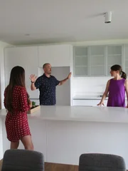 Portrait shot of agent Melanie Brealey with contributors Martin and Emily Wilson in Escazu, Costa Rica as seen on their house tour for House Hunters International.