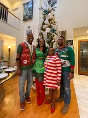 Dr. Ebonie posing with Family in front of Tree (Wide)