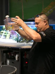 Wadye King and Brett Raymer work on the Gabriel Iglesias' Studio tank.