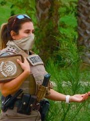 Warden Bailey holding book up.