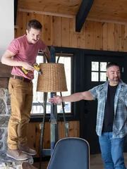 Rico Leon helps his team of Stephen and David Strussel place the finishing touches on the living room, as seen on Battle on the Mountain, Season 1.