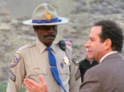 Monk (Tony Shalhoub, r.) steckt wegen einem Unfall im Stau fest. Als er sich das Unfallauto anschauen geht, fallen Monk sofort Ungereimtheiten auf, die auf ein Verbrechen statt auf einen Unfall hinweisen.