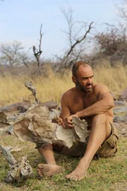 Ed Stafford cutting an animal hide in Namibia.