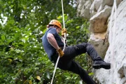 Puerto Rico - Gordon Ramsay repelling on a sheer rockface in a rainy forest in Puerto Rico.