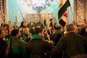 LONDON - Congregaton raises swords in the air as they form a circle during the Ashura ceremony in the Al-Khoei Foundation.