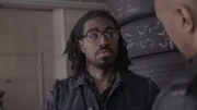 Man wearing glasses looks concerned.