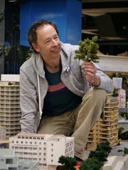 Gerrit Braun holding a miniature tree in his hand.