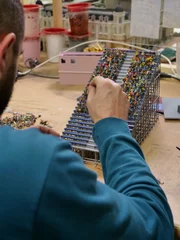 The process of placing tiny people in the stands.