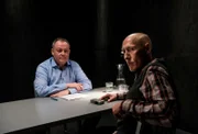Actor Detlef Bothe (R) and criminal investigator and profiler Stephan Harbort pose on set during the shooting for the new local production