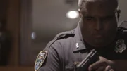 A cop points a gun.