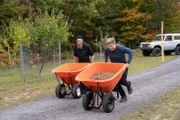 Michigan - L to R: Father Ephrem and Gordon Ramsay have a wheelbarrow race.