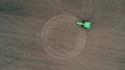 Aerial shot of tractor driving in field. (National Geographic/Michael Monar)