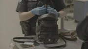 CBP Officer Pridmore checks bag of female traveler. (National Geographic)