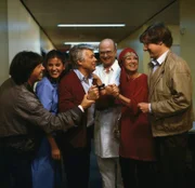 Aufregung herrscht im Flur des Krankenhauses, als der Arzt (Robert Dietl, 3. v. r.) Werner (Peter Weck, 3. v. l.) mitteilt, wie groß Franziska bei der Geburt war. Dabei sind seine Freunde Wolfgang (Herbert Herrmann, l.), Bille (Maria Sebaldt, 2. v. r.) und Alfons (Herbert Bötticher, r.).