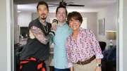 From left to right: Host David Bromstad, Hayden Balgavy, and Jane Balgavy pose for a picture in House 3, Dandelion Drop, as seen on My Lottery Dream Home, Season 16.
