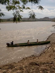 Chris and Ramon arriving on the river bank by boat.