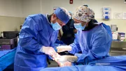 Dr. Brad performing surgery with crew