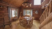 The dining room of the Open View Cabin is spacious with old western decor, as seen on HGTV's Log Cabin Living.