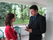 Detective talking to the mother on her porch.