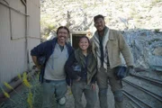 Participants William Sherman, Cassandra Bambi Tran, and Jesse Randolph Phillips smile at the Darwin Mine entrance.