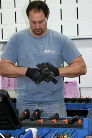 Inspector checking parts of Sig P229 pistol.