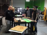 Brett and Trisha looking over the start of the building walls with DJ Ashba and his employee, Frank.