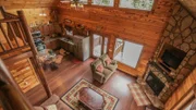 Looking down from the loft of the Broken Twig Cabin shows the open great room area, as seen on HGTV's Log Cabin Living.
