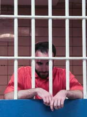 Michael waits behind bars.