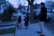 The Mascaro family shares a family moment on the sidewalk.