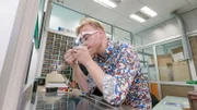 Axel wears magnifying glasses
