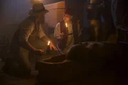Picture shows_Drama reconstruction - Loret and his assistant holding candles over a newly discovered sarcophagus.