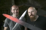 Monty and Stuart holding swords.