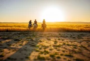 L-R: Kolinda, Otto, André riding towards the sunset.