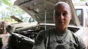 Kinessa helping repair the vehicle in Tanzania.