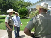 Wardens Powell and Thorne question a witness who called about illegal dove hunting in a residential neighborhood.