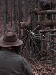 Trapper and Huckleberry looking on as Willy works on the trap outside.