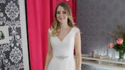 Episode 24. Bride Lillian S tries on her first and chosen dress. Dress: V neckline, wrapped tulle bodice, diamonte belt, full tulle skirt with lace edge by Ronald Joyce.