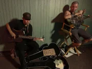 Corey, a cocaine user busking with his guitar.